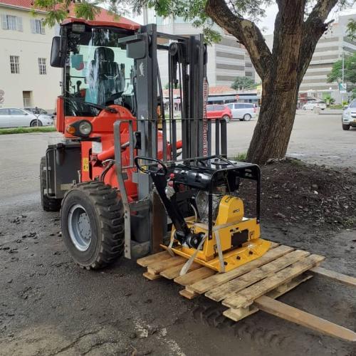 Forklift carrying plate compactor