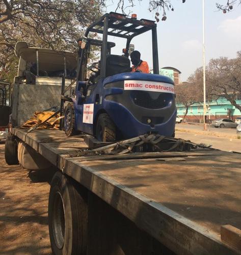 Transporting forklift to a project site.